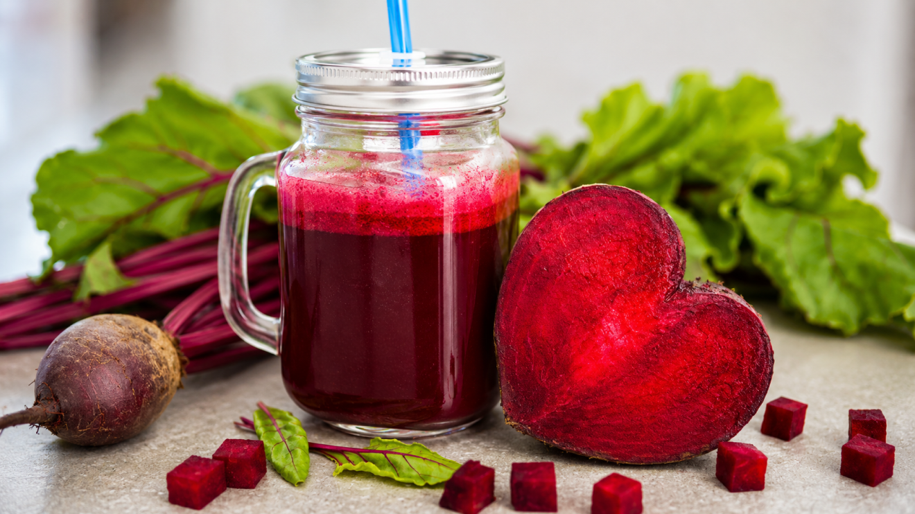 7 Beetroot Supplement Benefits You Should Know Before Taking 8 Mason Jar Filled With Deep Red Beet Juice Beside A Glowing Heart-Shaped Beet Slice, Fresh Beet Greens, And Diced Beet Cubes On A Countertop, With The Heart-Shaped Beetroot Symbolizing Beetroot’s Circulation-Supporting Properties And Its Potential Role In Boosting Sexual Performance And Vitality.